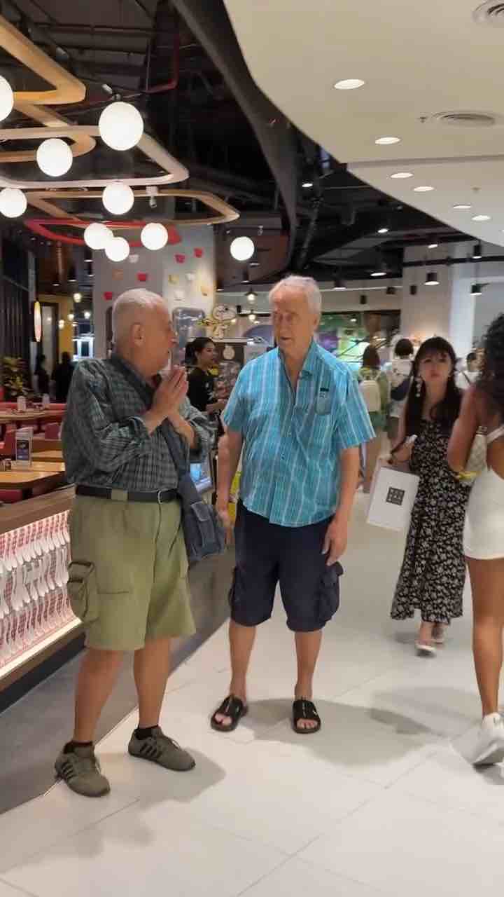 Elderly male tourist in Thailand praying at the sight of attractive woman walking past 😂