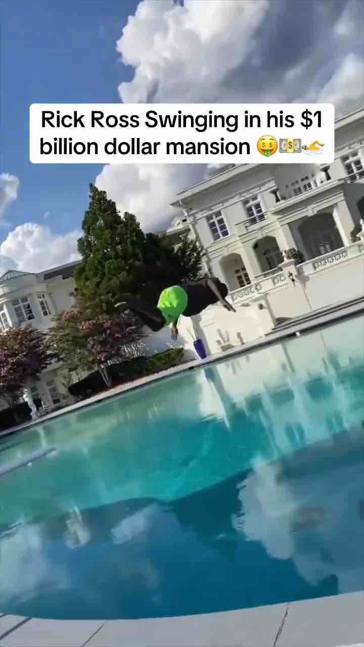 Rick Ross dives into swimming pool from diving board. That boy jumped high.